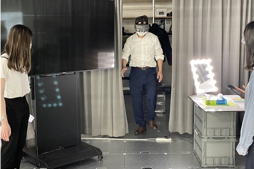 A man wearing an AR headset walks into a room