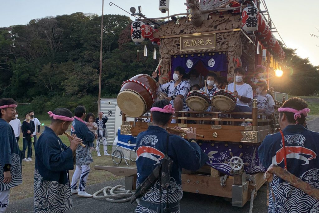 The children of the town play taiko drums on the portable shrine, making it feel like a festival