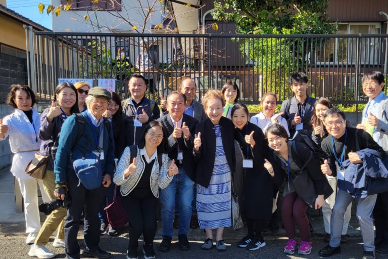 Participants pose with Dr. Akiyama outside Imaizumi Care Center